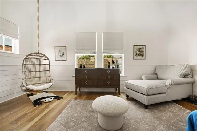 a living room with furniture a rug and a window