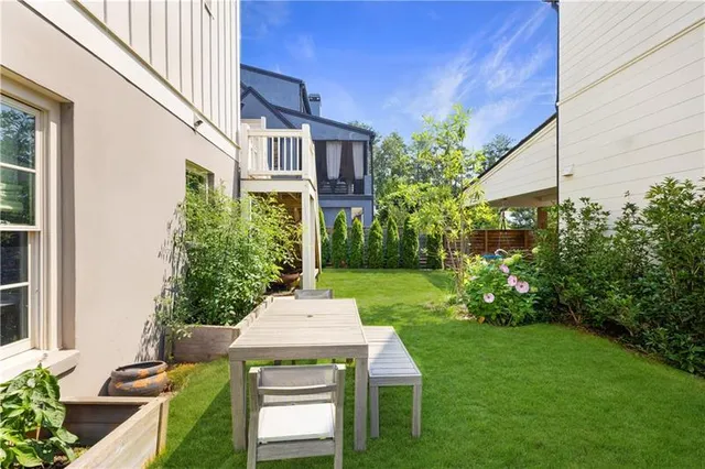 a view of a patio with table and chairs and potted plants