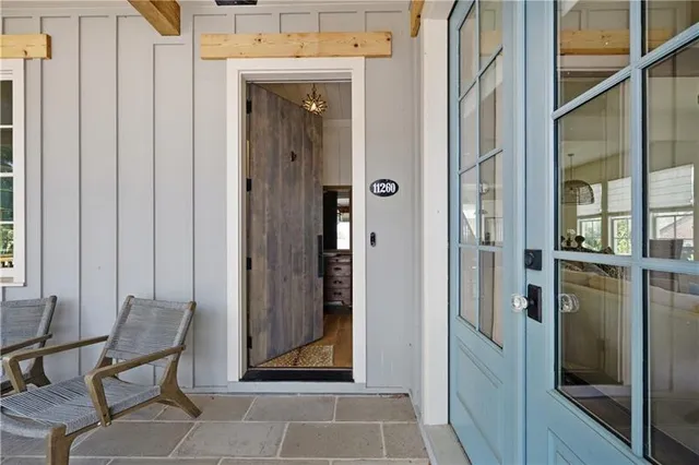 a view of a hallway with furniture and front door