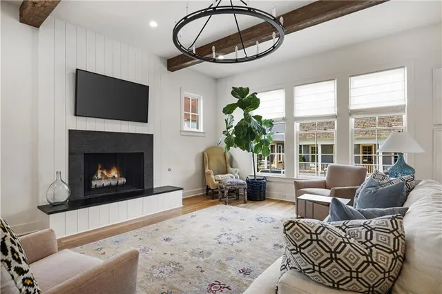 a living room with furniture a fireplace and a large window