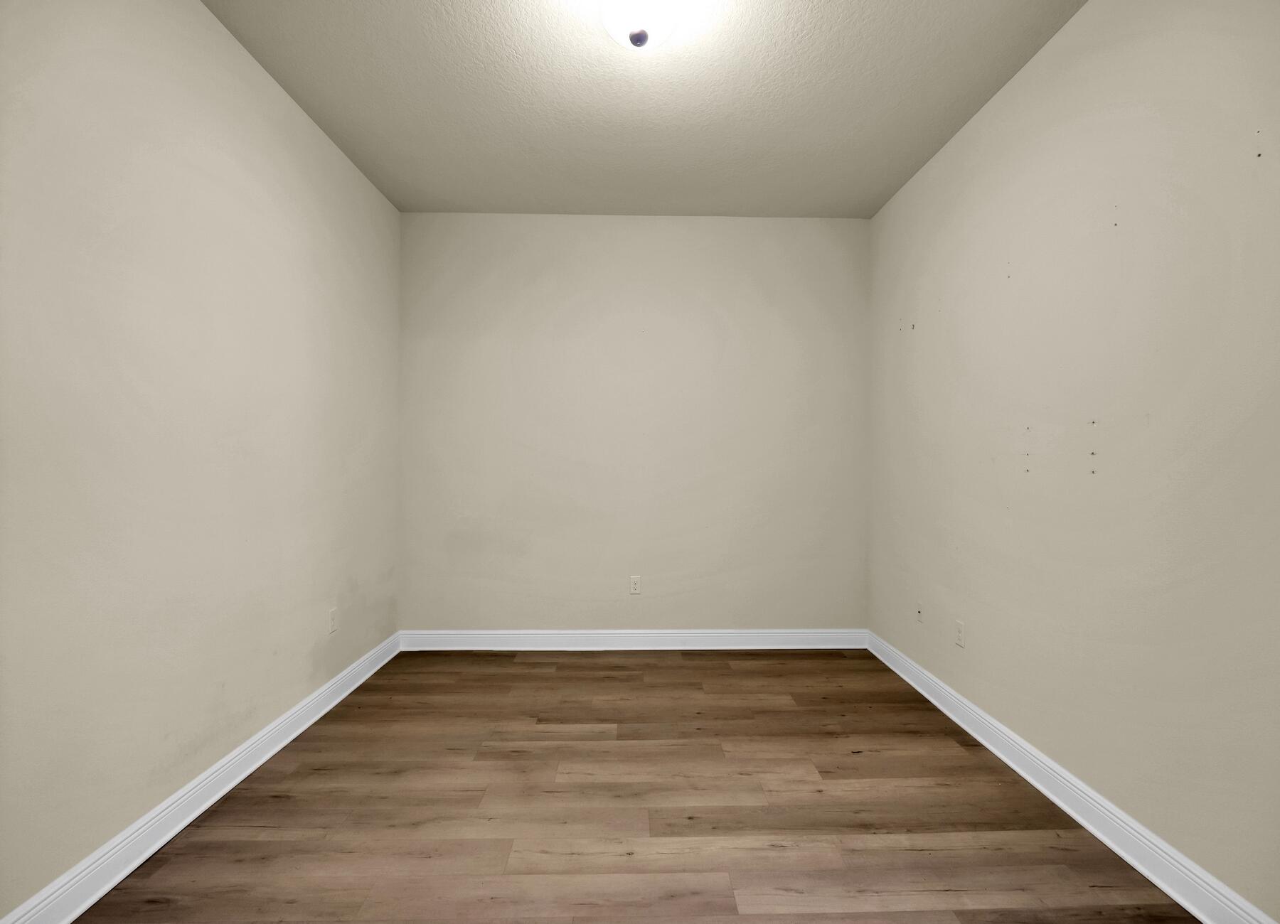 3639 Ranch Drive Crestview, FL 32539 - Photo 14 of 84 a view of an empty room with wooden floor