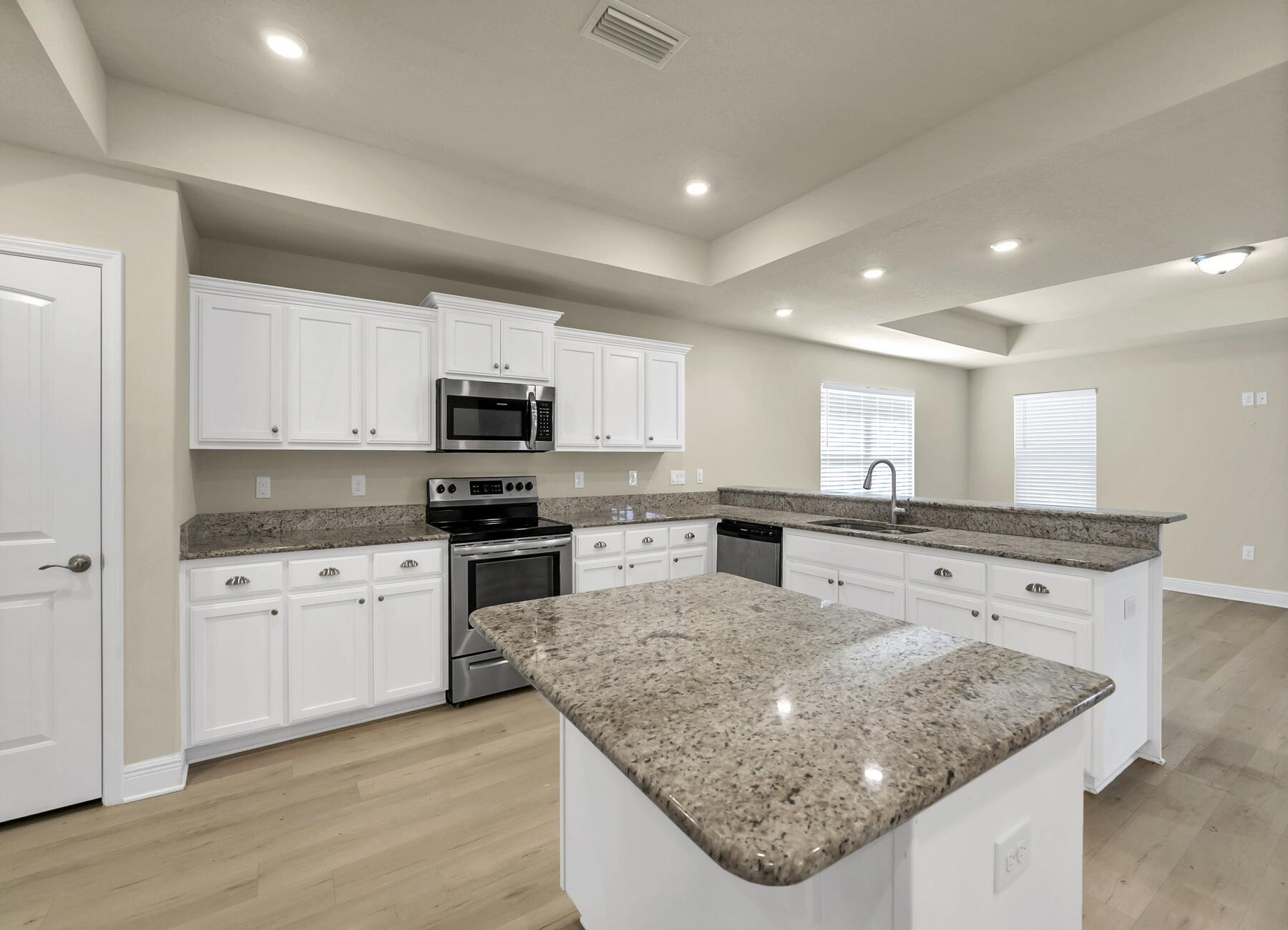 3639 Ranch Drive Crestview, FL 32539 - Photo 22 of 84 a kitchen with stainless steel appliances granite countertop a sink dishwasher and a stove with wooden floor