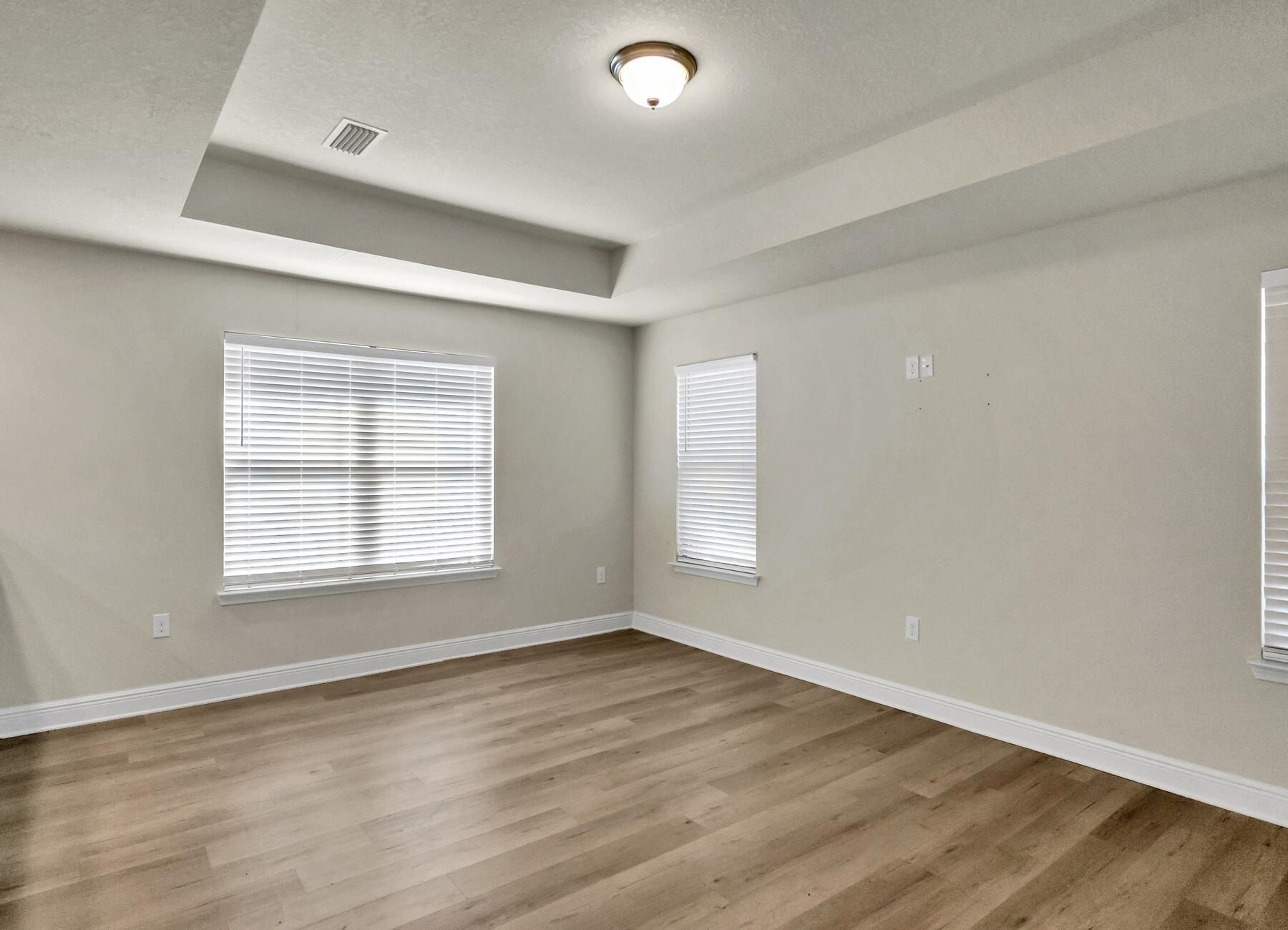 3639 Ranch Drive Crestview, FL 32539 - Photo 30 of 84 an empty room with wooden floor and windows