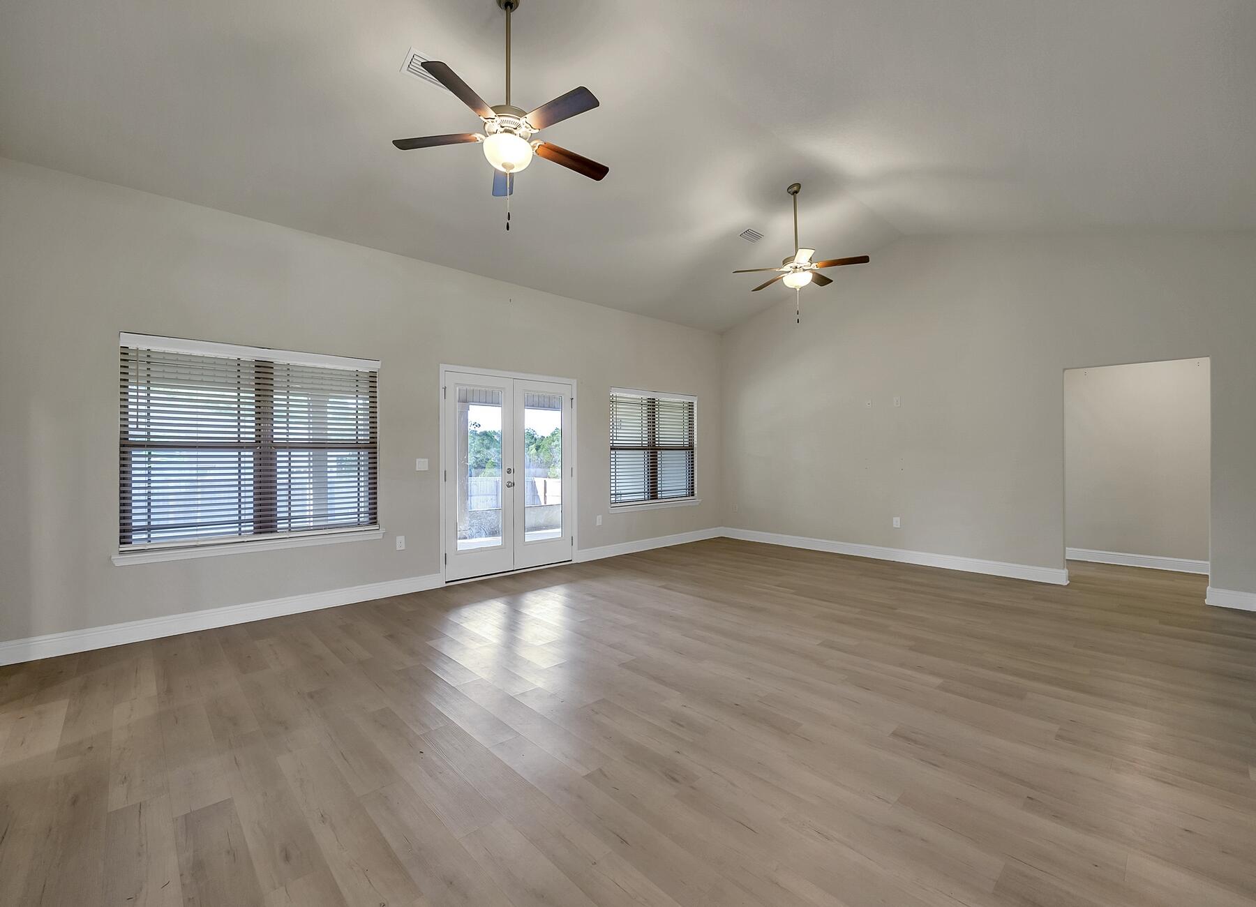 3639 Ranch Drive Crestview, FL 32539 - Photo 46 of 84 a view of an empty room with wooden floor and a ceiling fan