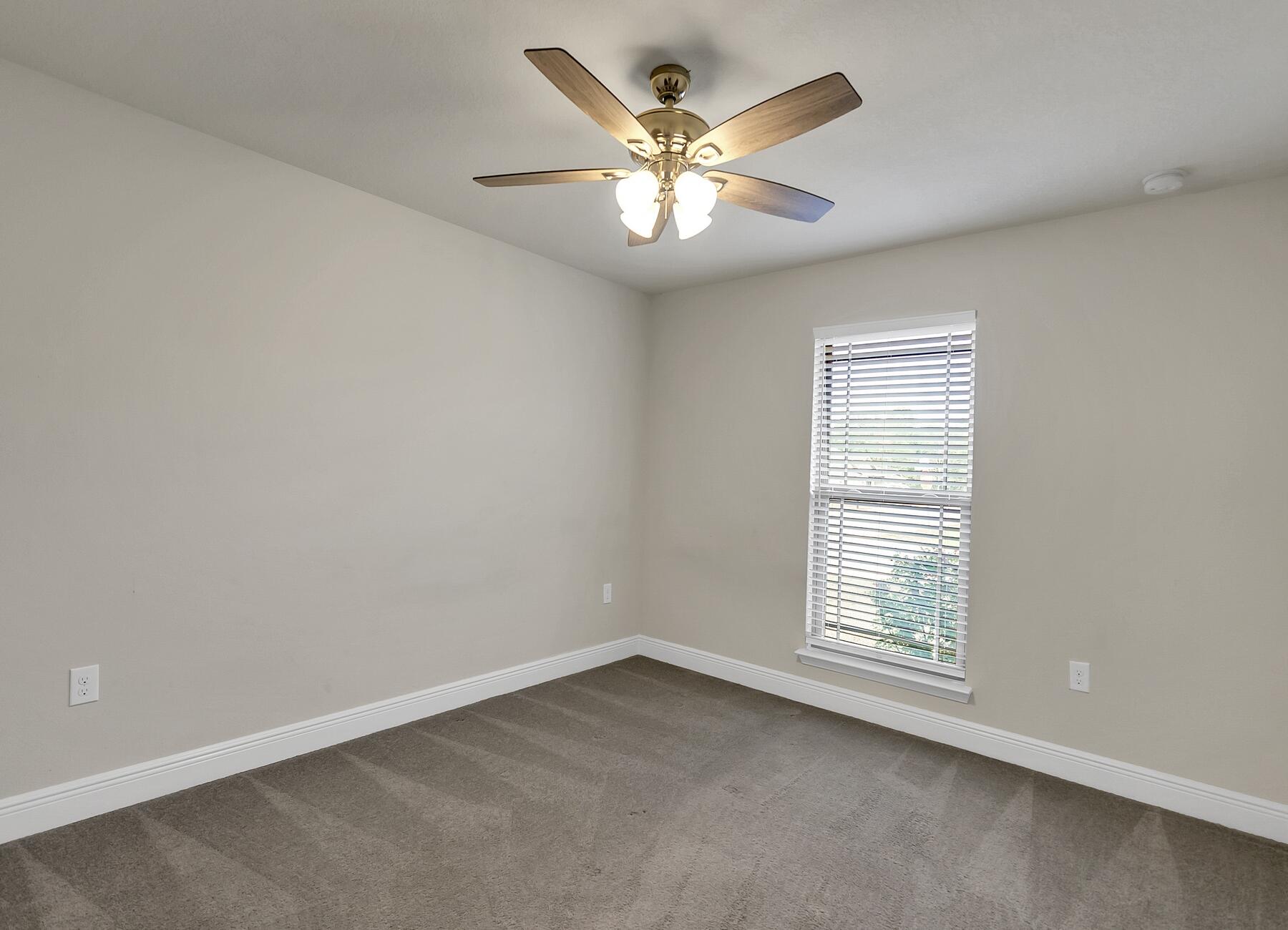 3639 Ranch Drive Crestview, FL 32539 - Photo 56 of 84 an empty room with window and ceiling fan