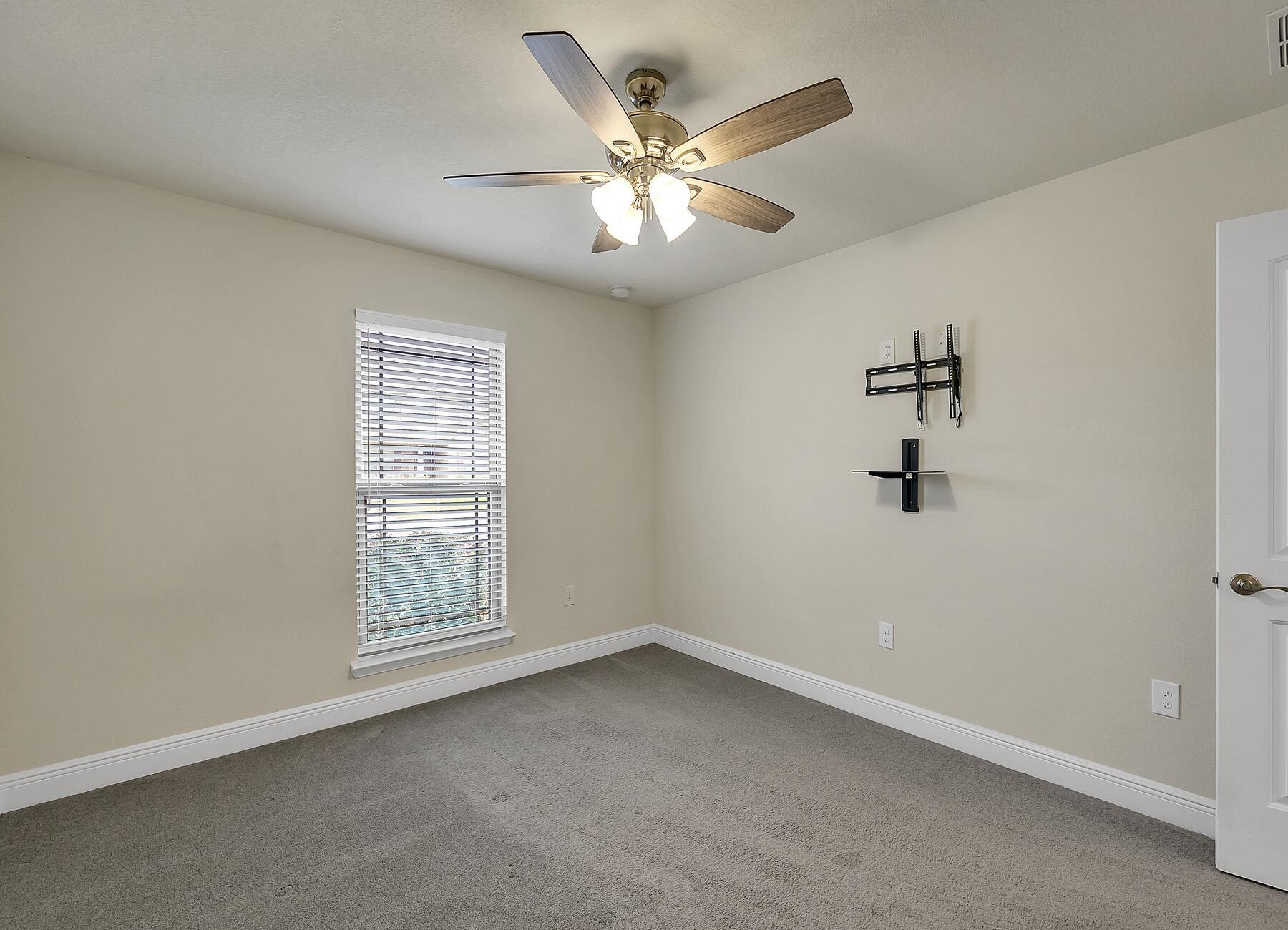 3639 Ranch Drive Crestview, FL 32539 - Photo 57 of 84 an empty room with windows and fan