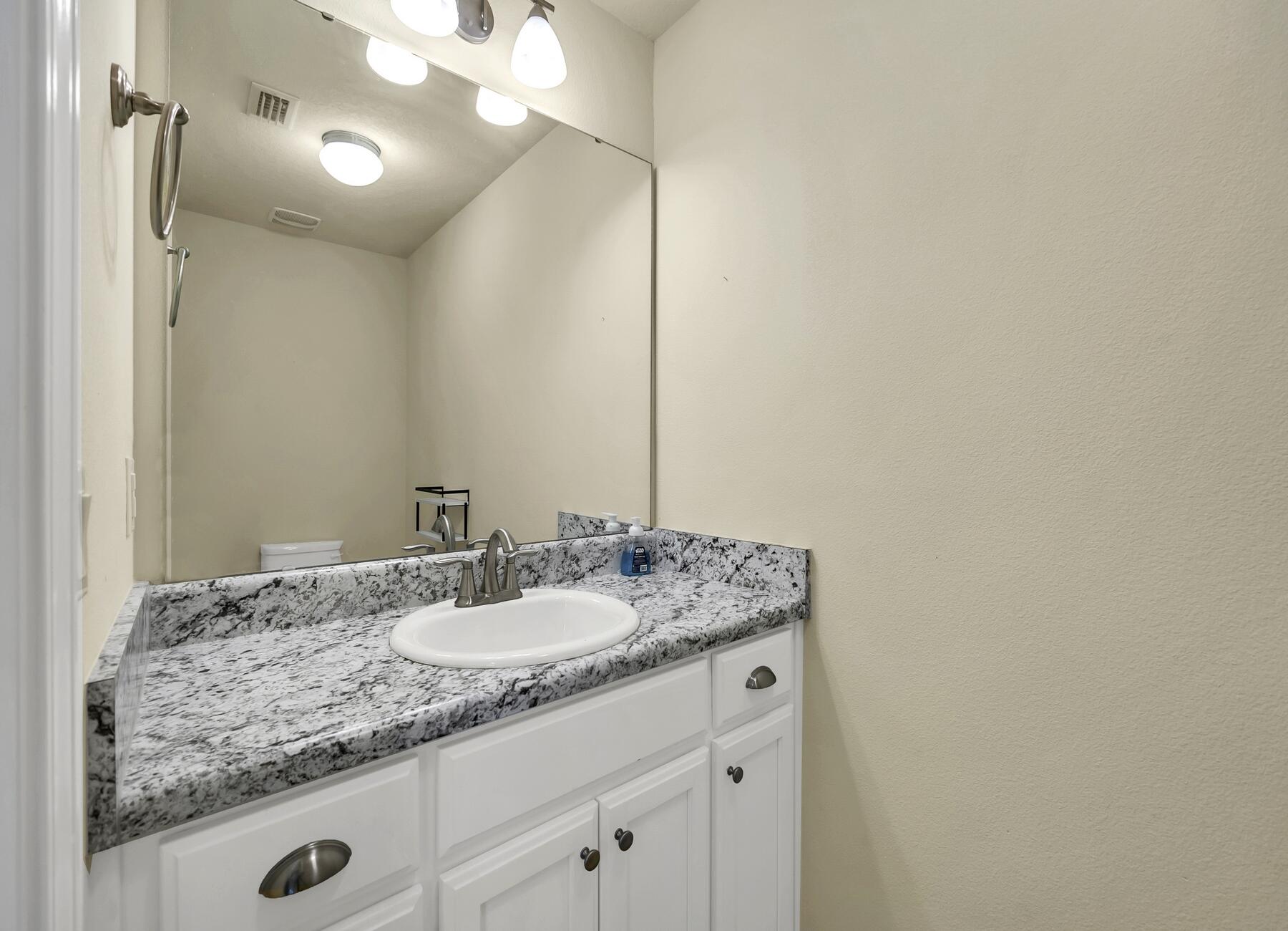 3639 Ranch Drive Crestview, FL 32539 - Photo 68 of 84 a bathroom with a granite countertop sink and a mirror