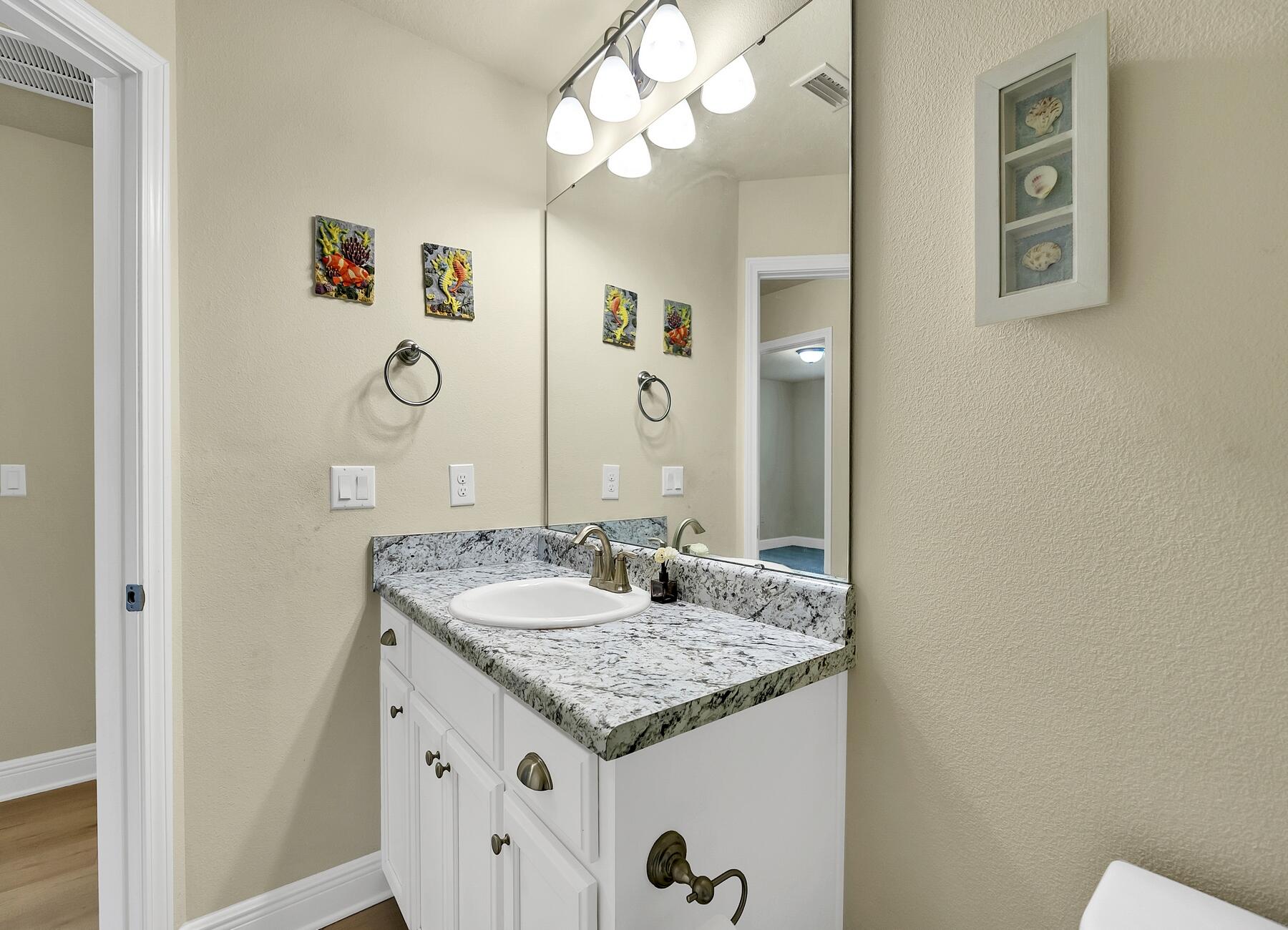 3639 Ranch Drive Crestview, FL 32539 - Photo 79 of 84 a bathroom with a granite countertop sink and a mirror