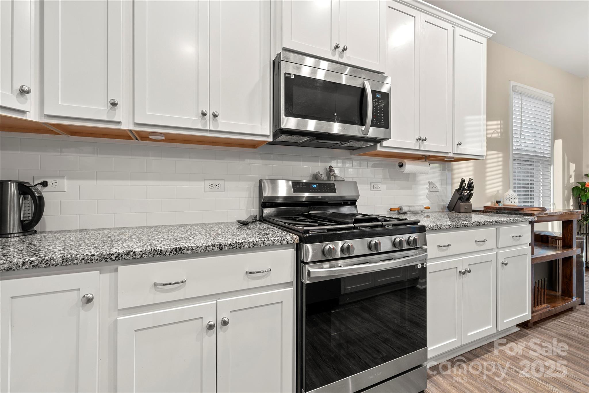1990 Ambrose Way Denver, NC 28037 - Photo 4 of 40 a kitchen with granite countertop white cabinets and stainless steel appliances