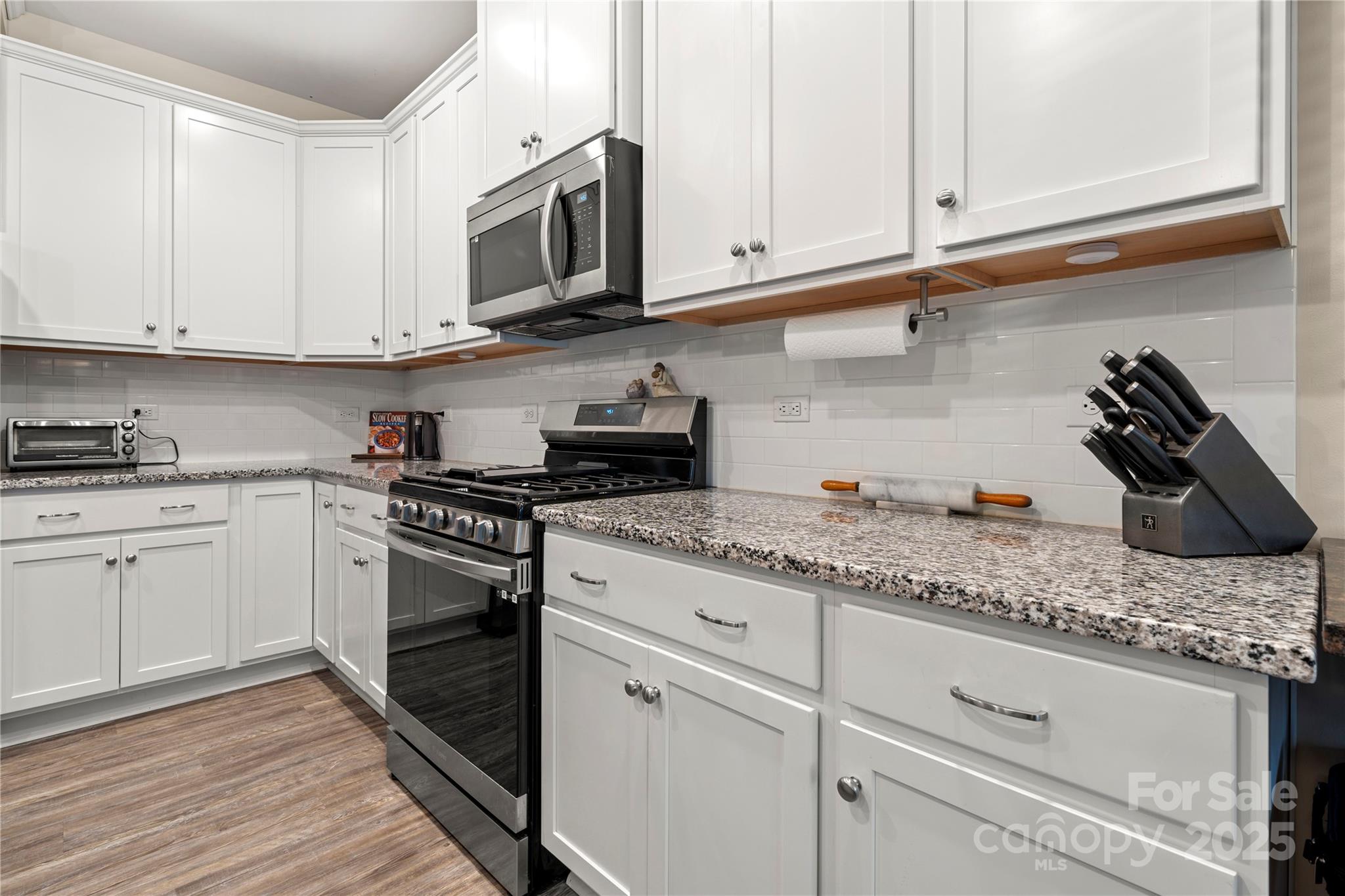 1990 Ambrose Way Denver, NC 28037 - Photo 5 of 40 a kitchen with granite countertop white cabinets and a stove