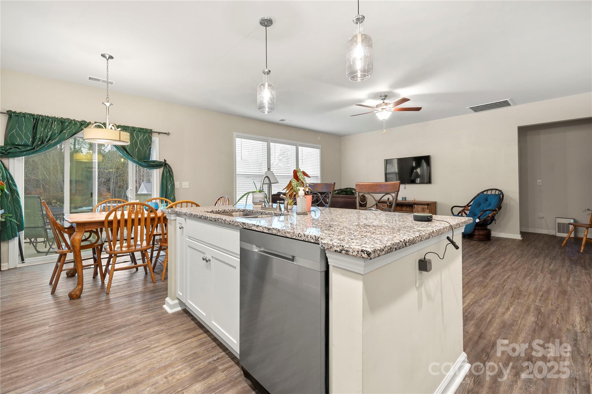 1990 Ambrose Way Denver, NC 28037 - Photo 8 of 40 a open kitchen with stainless steel appliances granite countertop a kitchen island a stove a sink a dining table and chairs with wooden floor