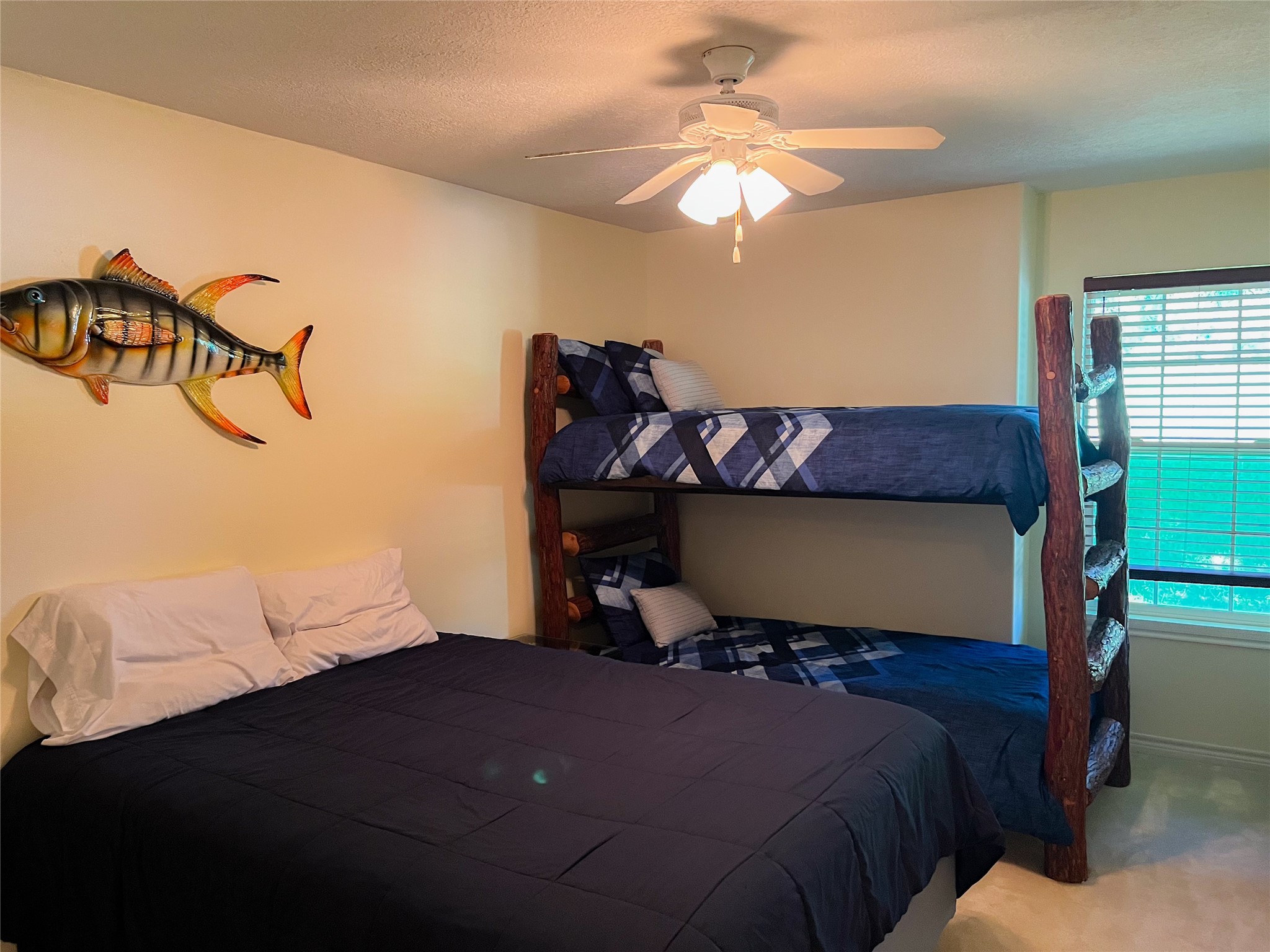 231 Memphis Belle Trinity, TX 75862 - Photo 31 of 47 a bedroom with a bed and a chandelier