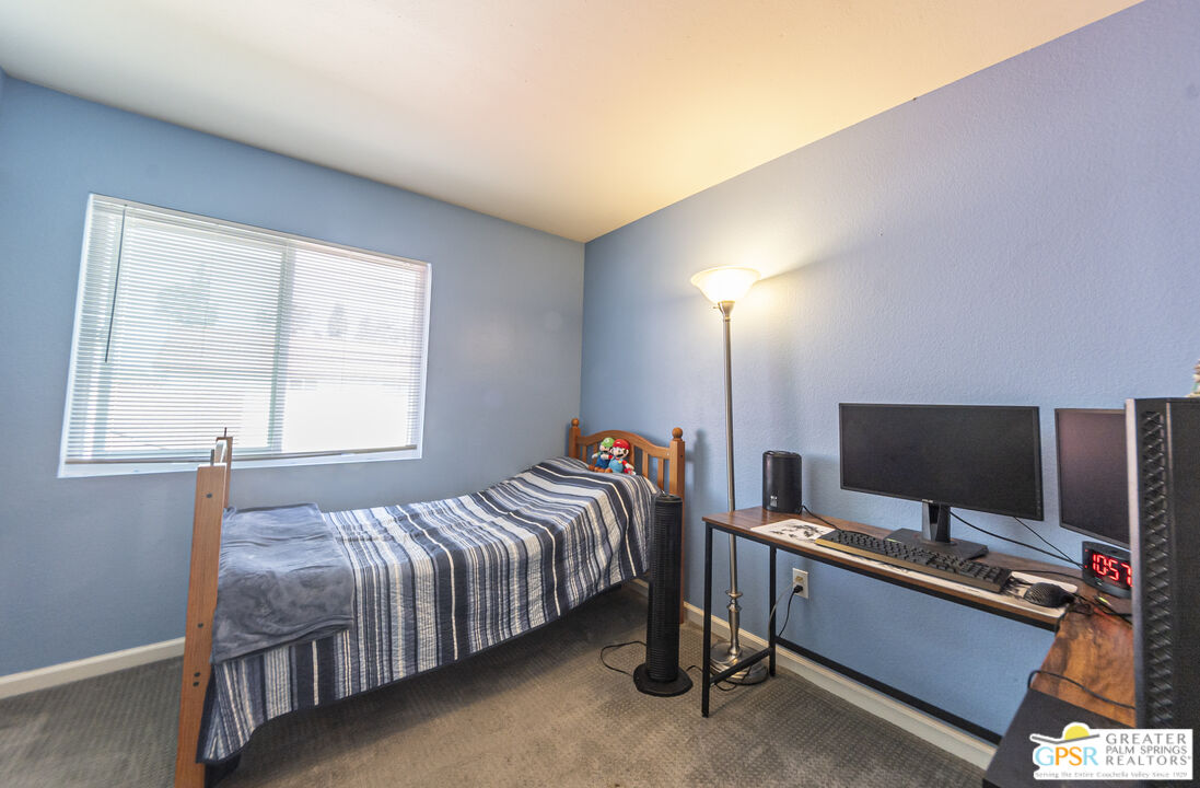2853 Bragg Street Riverside, CA 92503 - Photo 27 of 43 a bedroom with a bed and a flat screen tv