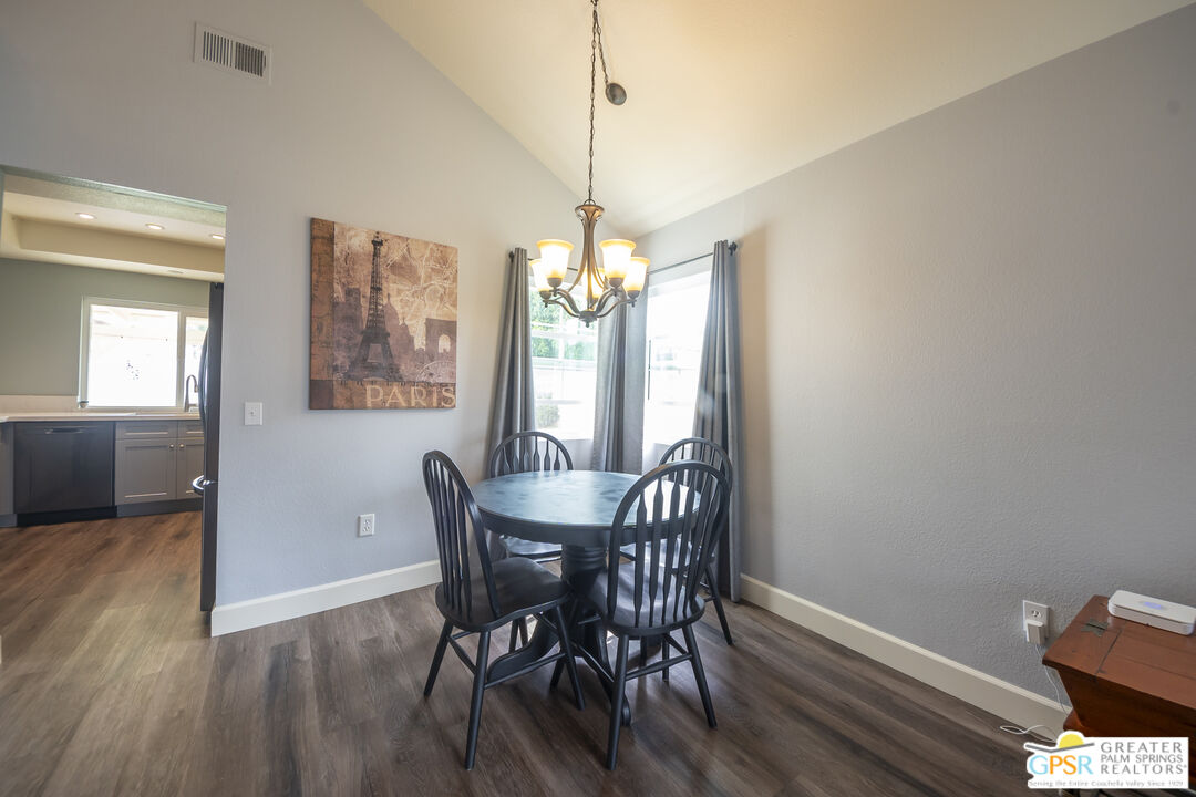 2853 Bragg Street Riverside, CA 92503 - Photo 7 of 43 a dining room with furniture a chandelier and wooden floor