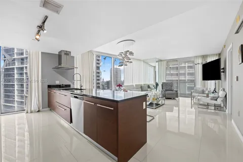a kitchen with stainless steel appliances a refrigerator and a sink