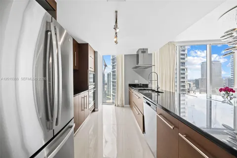 a kitchen with stainless steel appliances granite countertop a sink and cabinets