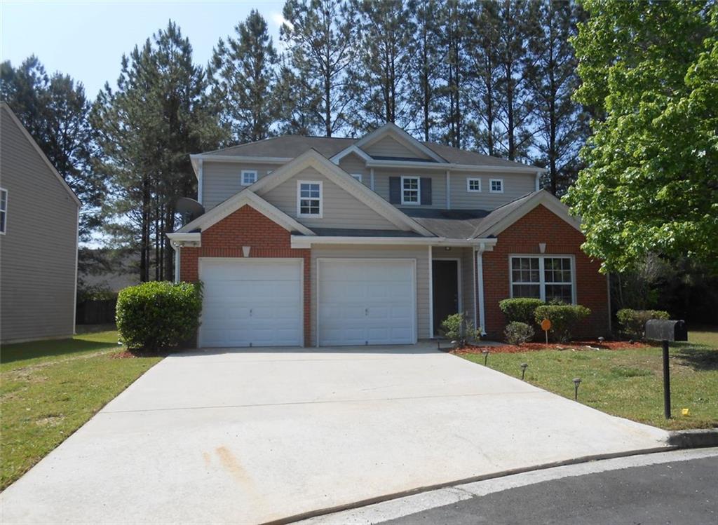 3069 Sable Run Road Atlanta, GA 30349 - Photo 1 of 1 a front view of a house with a yard and garage