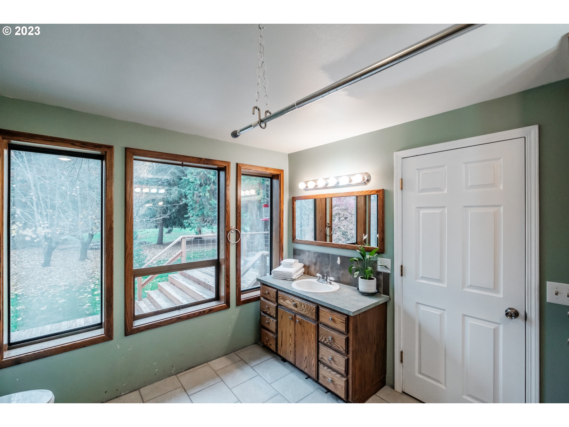 30115 Berlin Road Lebanon, OR 97355 - Photo 21 of 48 a bathroom with a double vanity sink a mirror and a bathtub