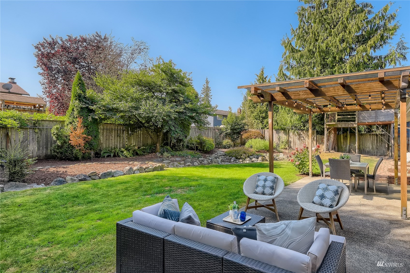 314 213th Place Southwest Bothell, WA 98021 - Photo 22 of 29 a backyard of a house with table and chairs
