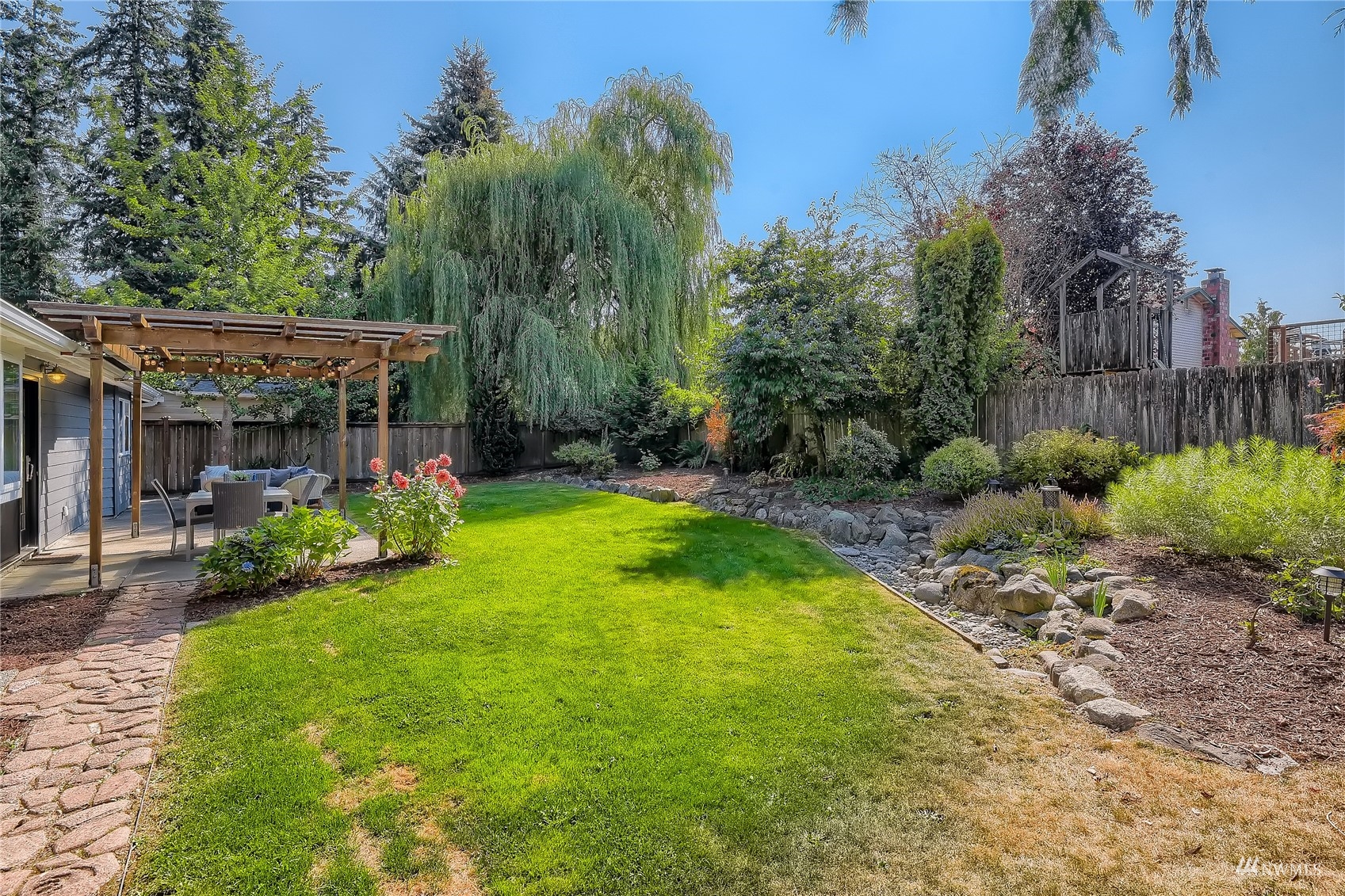314 213th Place Southwest Bothell, WA 98021 - Photo 26 of 29 a view of a chair and table in backyard of the house