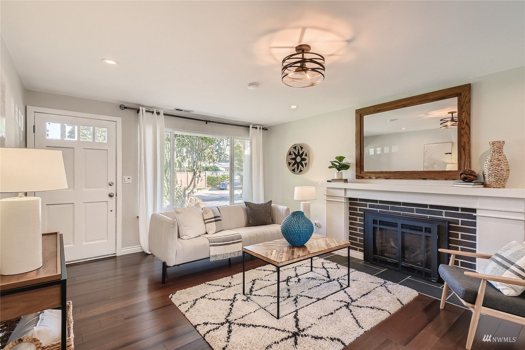 314 213th Place Southwest Bothell, WA 98021 - Photo 3 of 29 a living room with furniture a fireplace and wooden floor