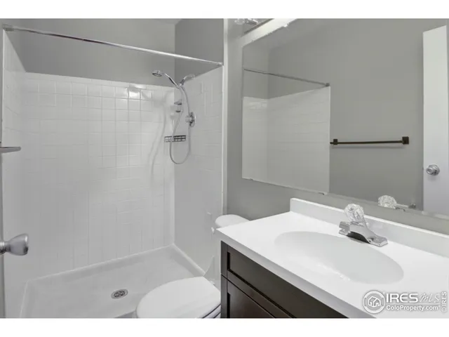a bathroom with a sink a shower and a mirror