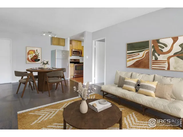 a living room with furniture and painting on the wall