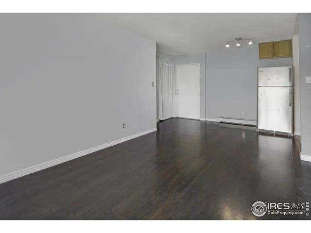 a view of an empty room and wooden floor