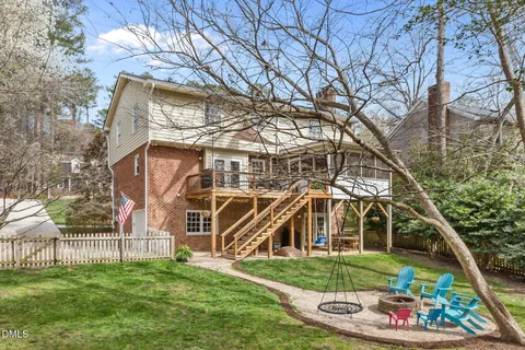 a view of a patio with table and chairs and floor to ceiling window