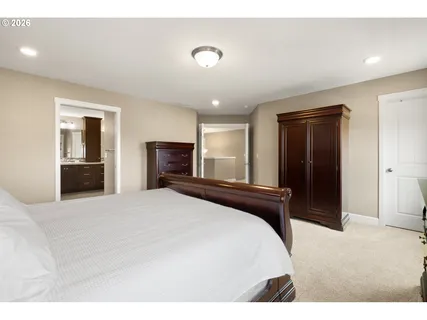 a bedroom with a bed and a television