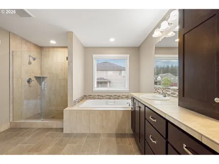 a bathroom with a sink mirror double vanity and a bathtub