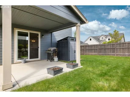a view of a backyard with table and chairs and potted plants