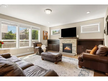 a living room with furniture a fireplace and a flat screen tv