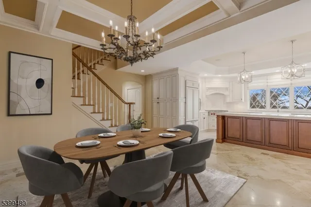 a view of a dining room with furniture and a chandelier