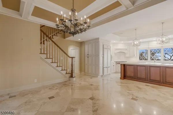 a view of a hallway with a chandelier and livingroom