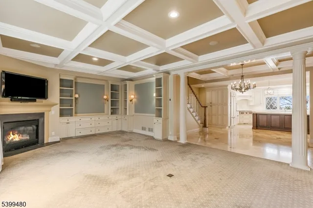 a view of an empty room with a fireplace and a window