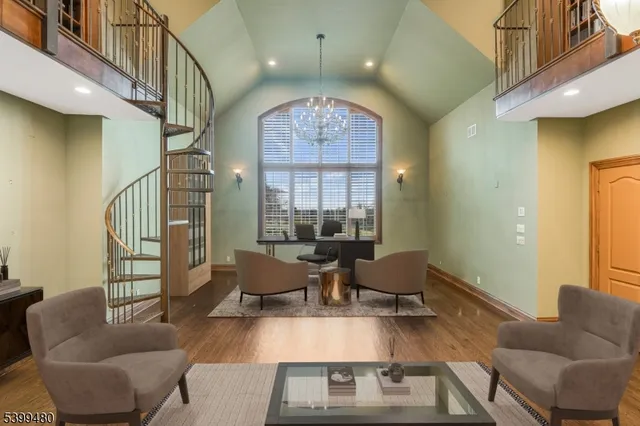 a living room with furniture a fireplace and a chandelier