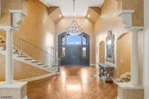 a view of a hallway with entryway wooden floor and front door
