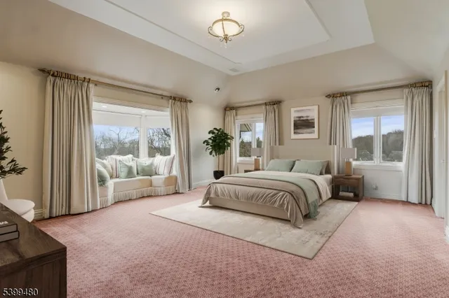 a spacious bedroom with a large bed and a large window