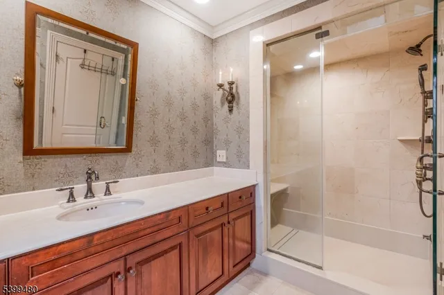 a bathroom with a shower sink and mirror