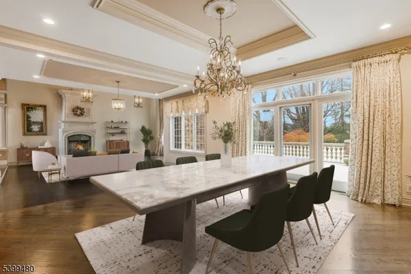 a view of a dining room with furniture wooden floor and chandelier