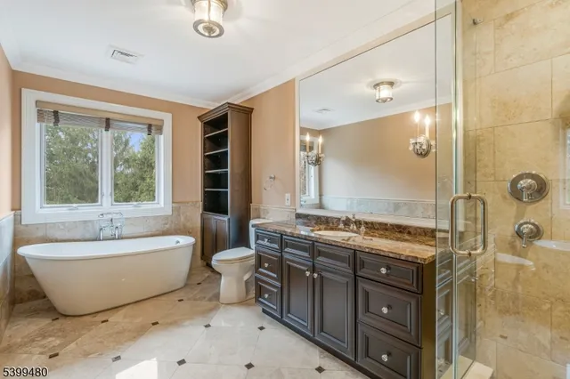 a spacious bathroom with a tub sink and mirror