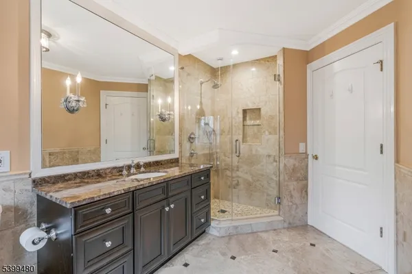 a bathroom with a granite countertop sink a mirror a shower and a bathtub