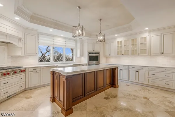 a large kitchen with cabinets a sink and dishwasher