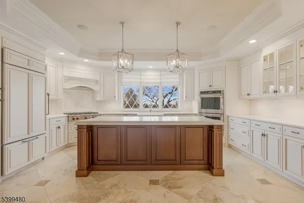 a kitchen with stainless steel appliances granite countertop a stove refrigerator and cabinets