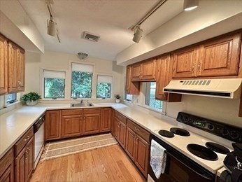 5 Amity Place, Unit 5 Amherst, MA 01002 - Photo 12 of 39 a kitchen with a sink stove top oven and cabinets