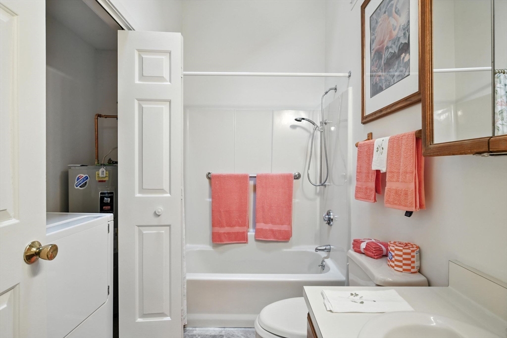 5 Amity Place, Unit 5 Amherst, MA 01002 - Photo 16 of 39 a bathroom with a tub shower sink and mirror
