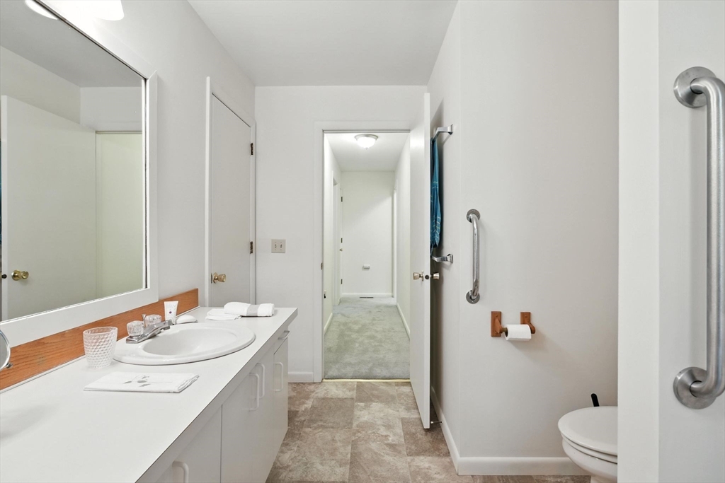 5 Amity Place, Unit 5 Amherst, MA 01002 - Photo 28 of 39 a bathroom with a granite countertop sink a toilet and shower