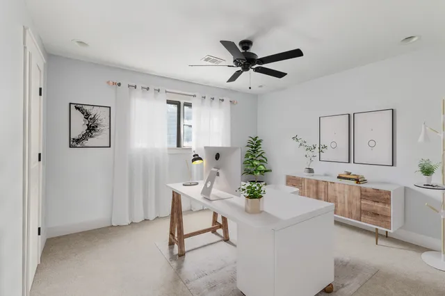 a living room with stainless steel appliances furniture cabinets and a window