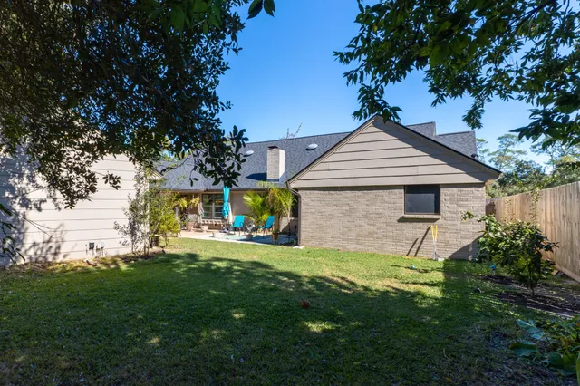 a front view of a house with a garden and yard